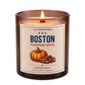 Lit Boston Pumpkin Spice scented candle by Le Flâneur Home in an amber glass jar with a wooden wick.