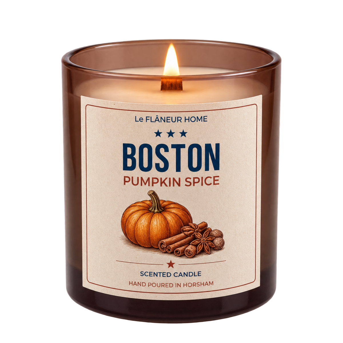 Lit Boston Pumpkin Spice scented candle by Le Flâneur Home in an amber glass jar with a wooden wick.