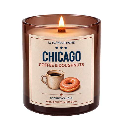Lit Chicago Coffee & Doughnuts scented candle by Le Flâneur Home in an amber glass jar with a wooden wick.