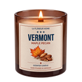 Lit Vermont Maple Pecan scented candle by Le Flâneur Home in an amber glass jar with a wooden wick.