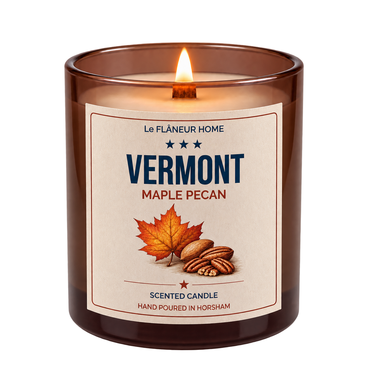 Lit Vermont Maple Pecan scented candle by Le Flâneur Home in an amber glass jar with a wooden wick.