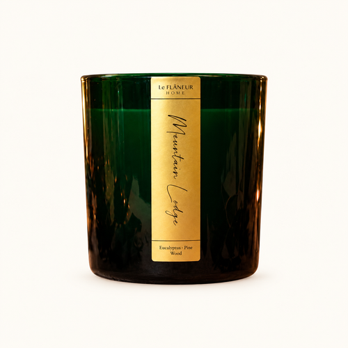 Mountain Lodge Scented Candle by Le Flâneur Home, unlit on an ivory background.