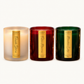 Le Flâneur Home Winter Collection trio: unlit Fireside Stories, Festive Memories and Mountain Lodge candles on an ivory background.